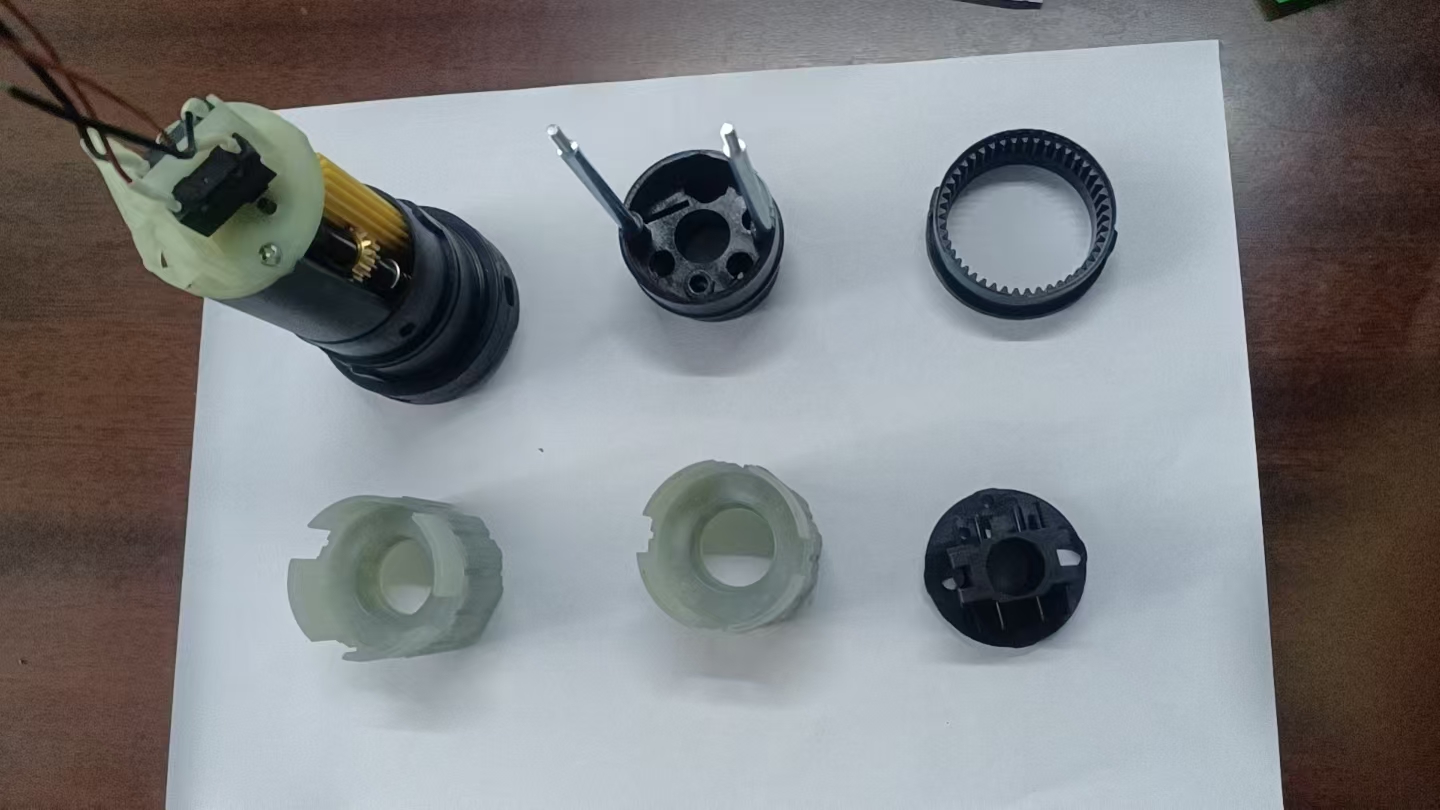 Full uncropped photograph of molded parts arranged with a partial assembly