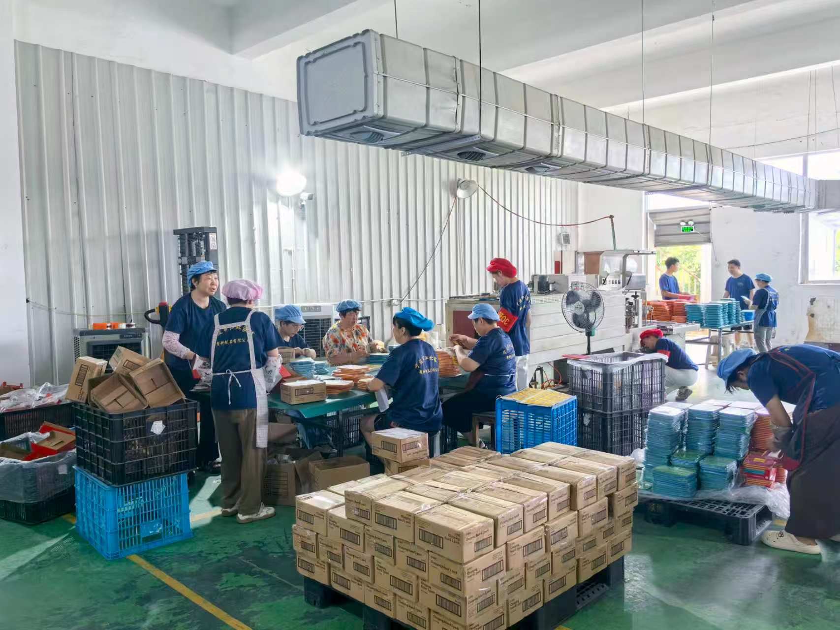 Packing line with workers preparing finished goods
