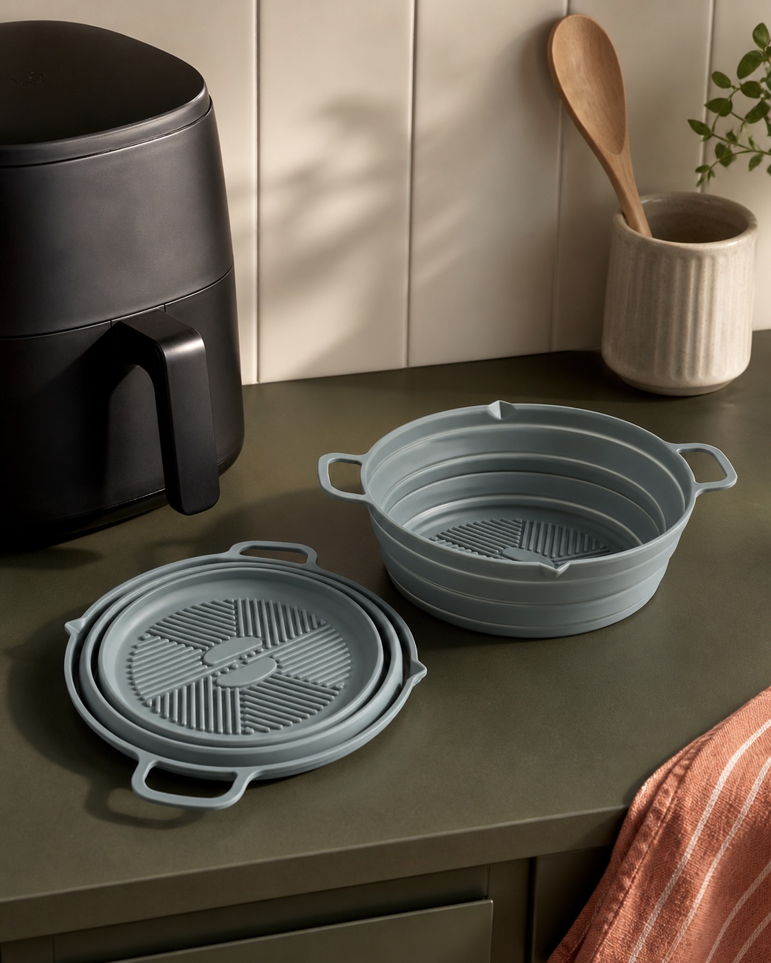 Silicone kitchen liners beside an air fryer